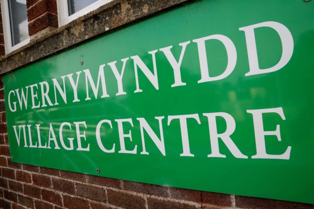 Gwernymynydd Village Centre sign on outside of village hall.